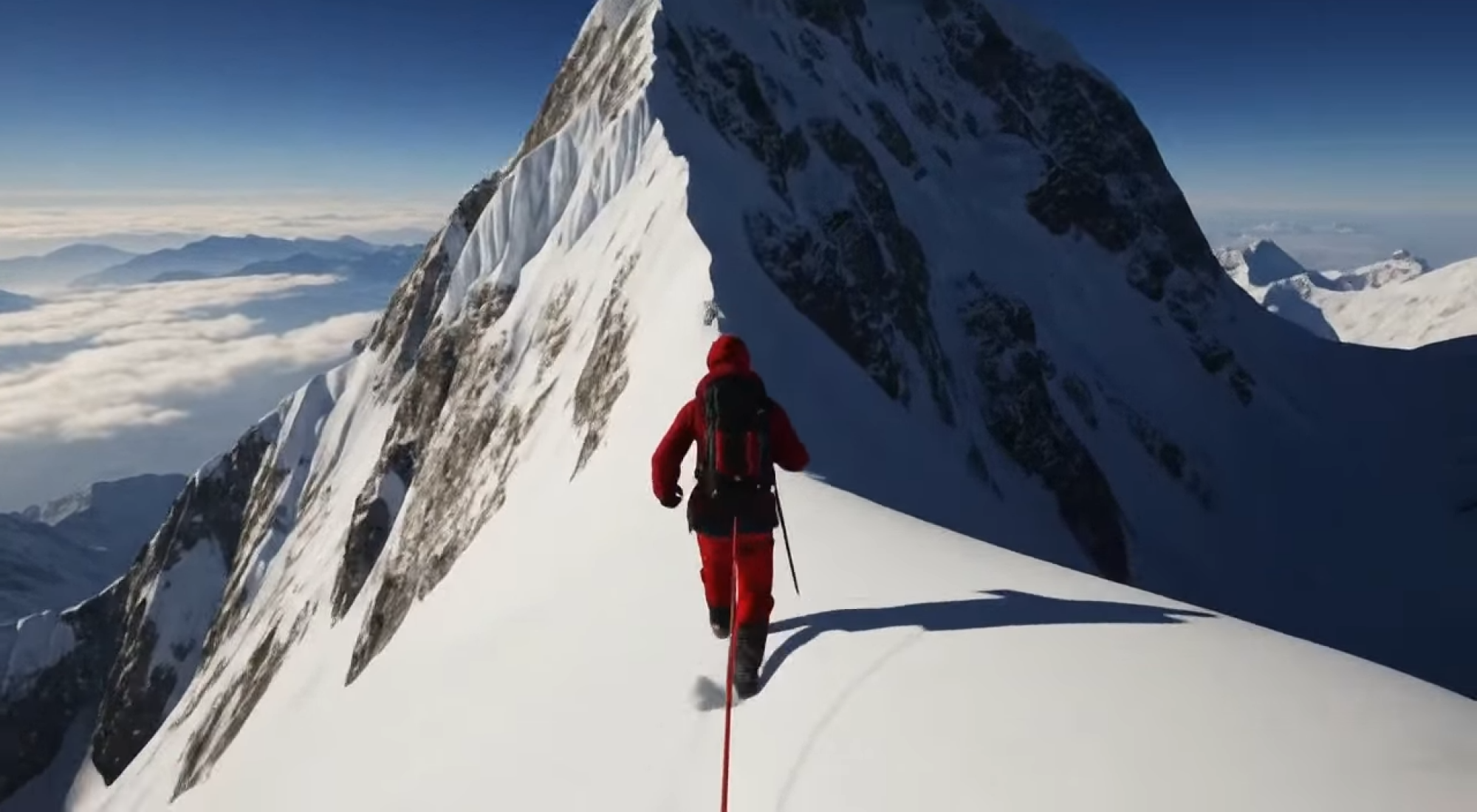 a climber on a mountain in a world created by project genie