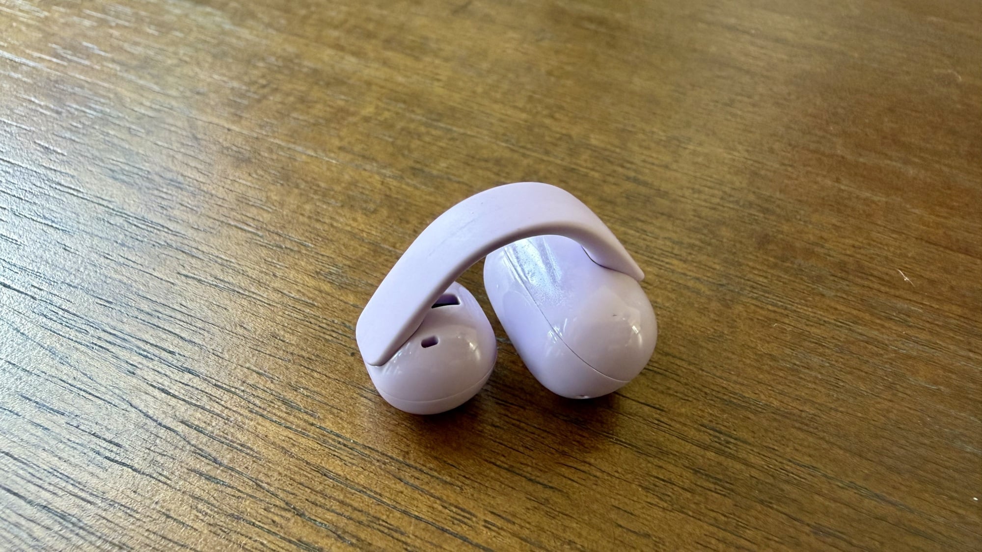 close up of purple sony linkbuds clip earbud on table