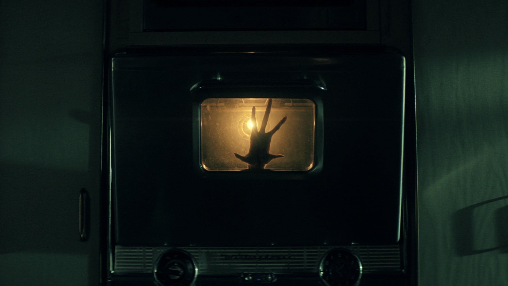 A monster's hand creeping out of an oven.