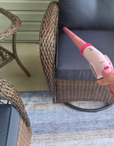 Leah using Shark BlastBoss to clean porch furniture