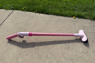 Shark BlastBoss with broom attachment on sidewalk near grass