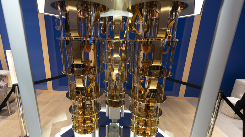 A gold-colored IBM quantum computer is shown at a trade shown