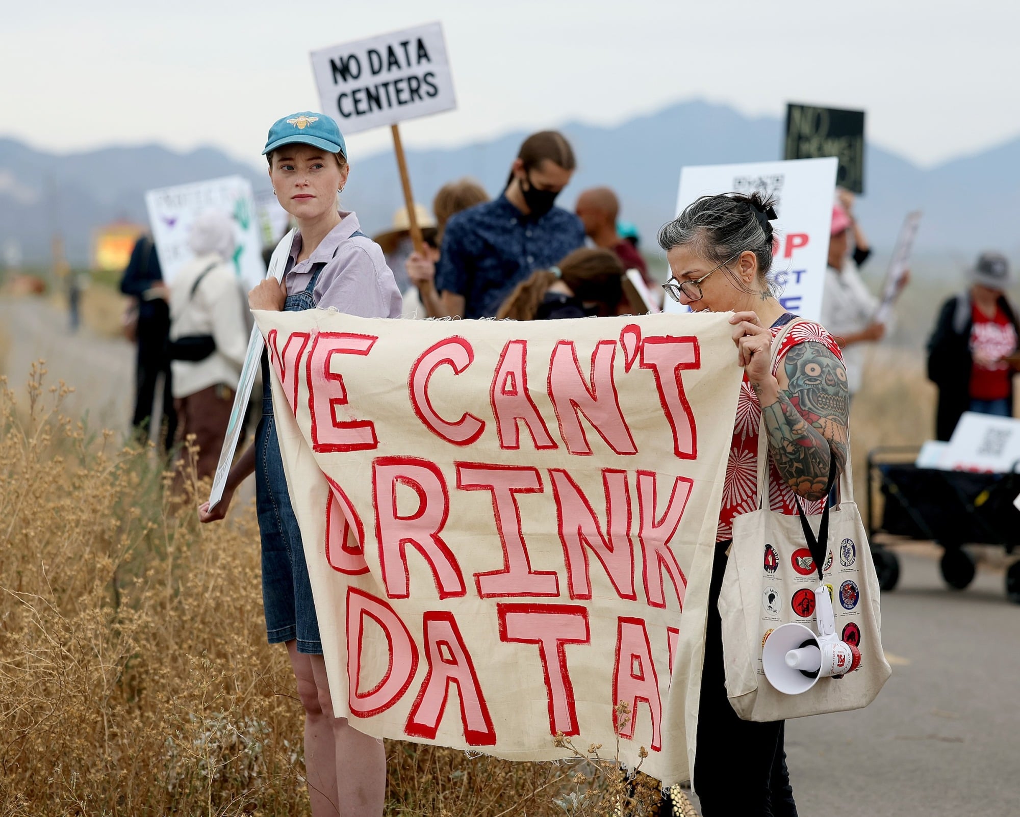 Demonstrators hold signs during a protest against the Project Blue data center in Tucson, Arizona