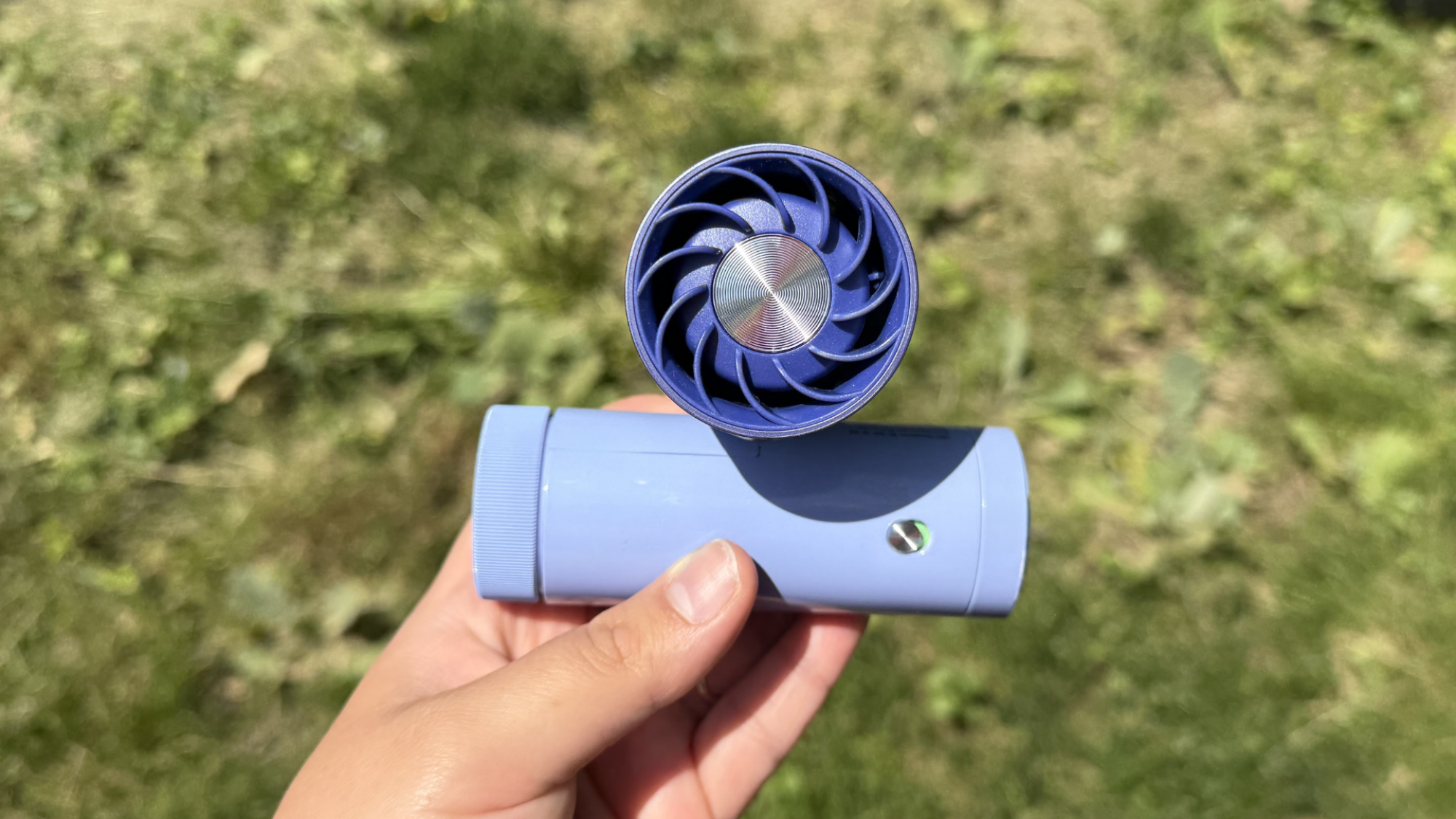person holding Shark ChillPill over grass
