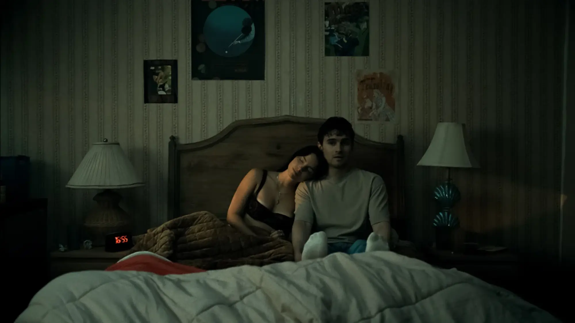 Inde Navarrette as Nikki and Michael Johnston as Bear laying in bed in "Obsession" movie