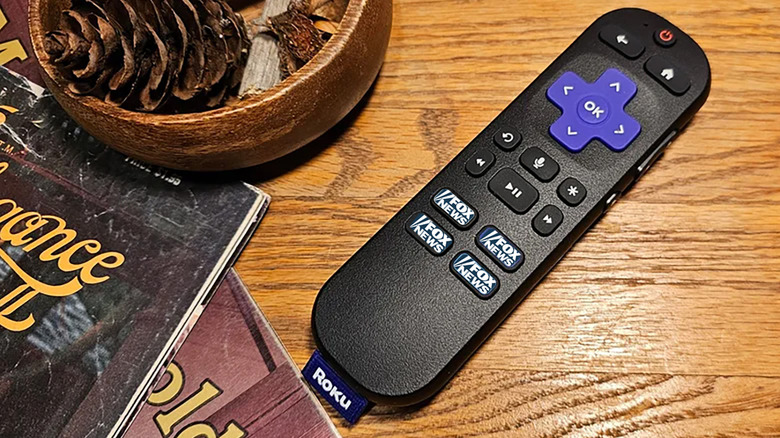 A Roku remote on a table with Fox News (Photoshopped) on all the channel buttons