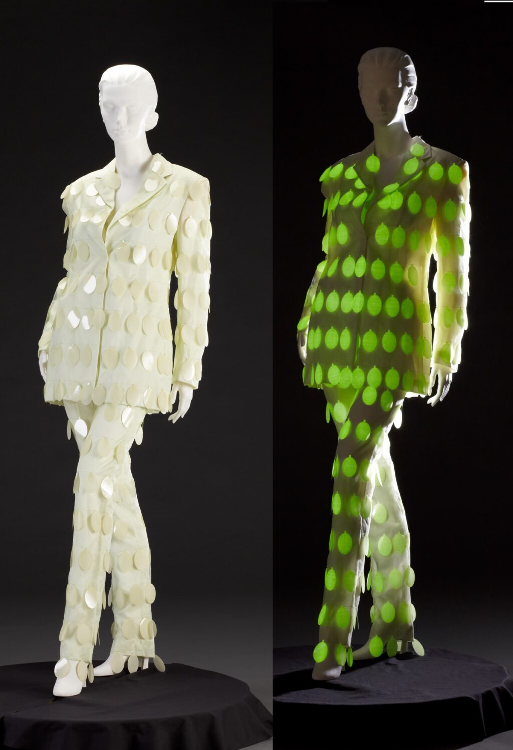 A pantsuit adorned with phosphorescent paillettes appears white in normal, visible light but glows green in the dark.