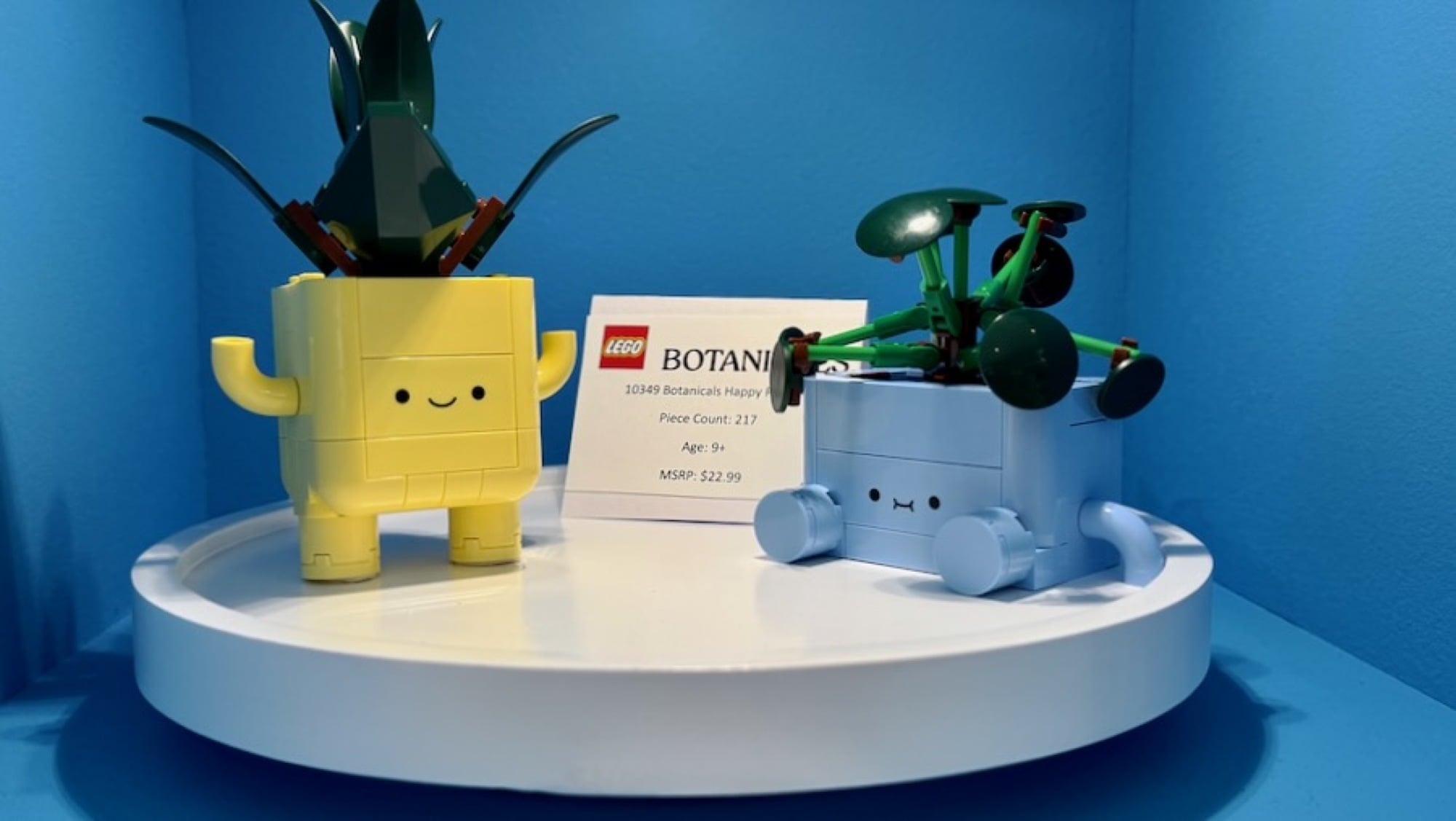 lego tiny plants on a small plinth with a display card
