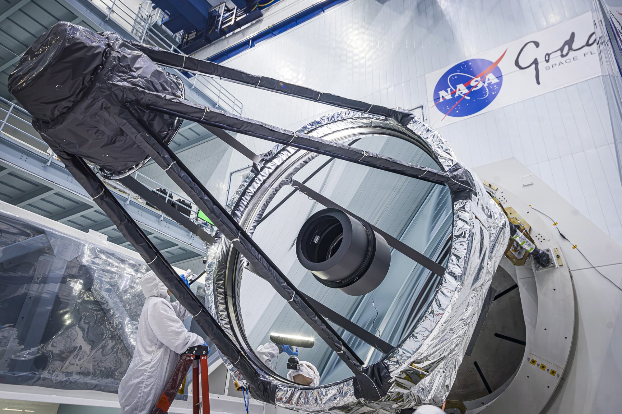 An engineer inspecting the Roman Space Telescope's primary mirror