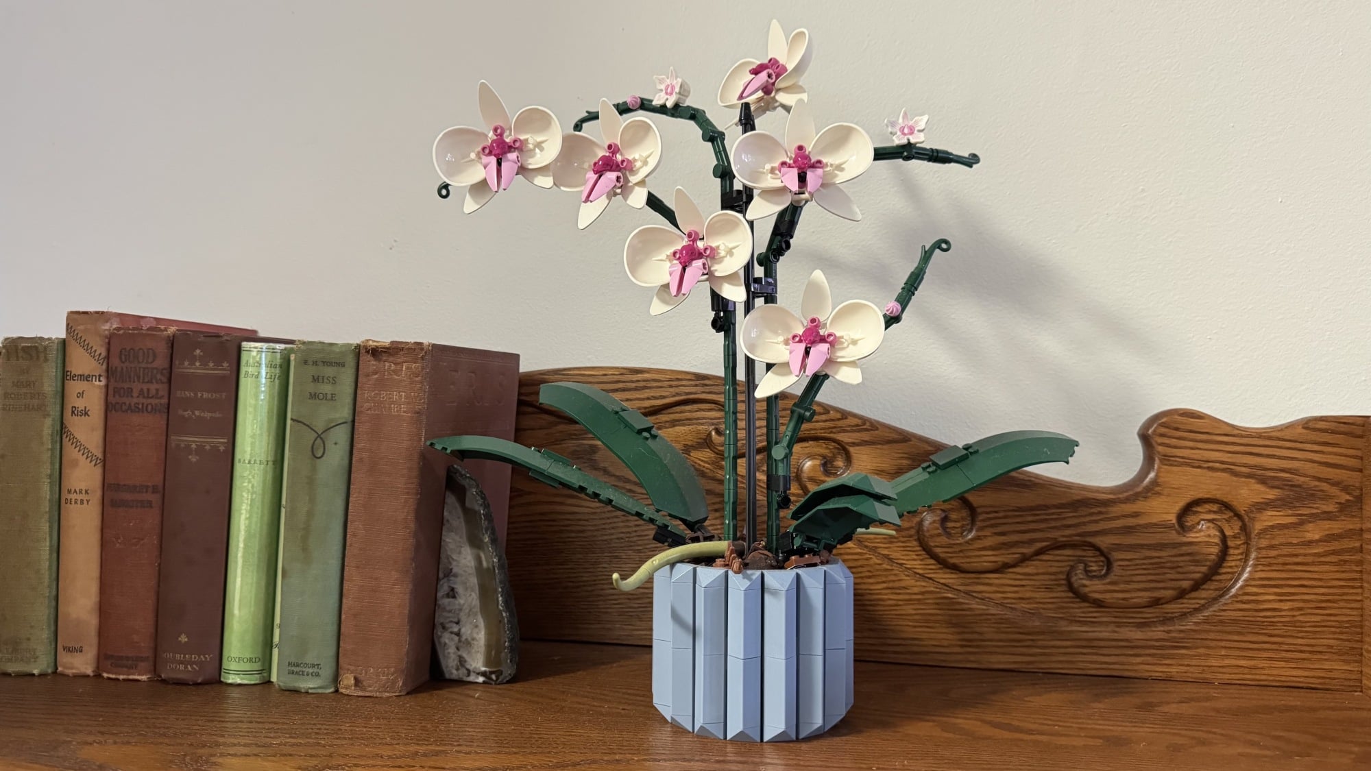lego orchids set on bookshelf