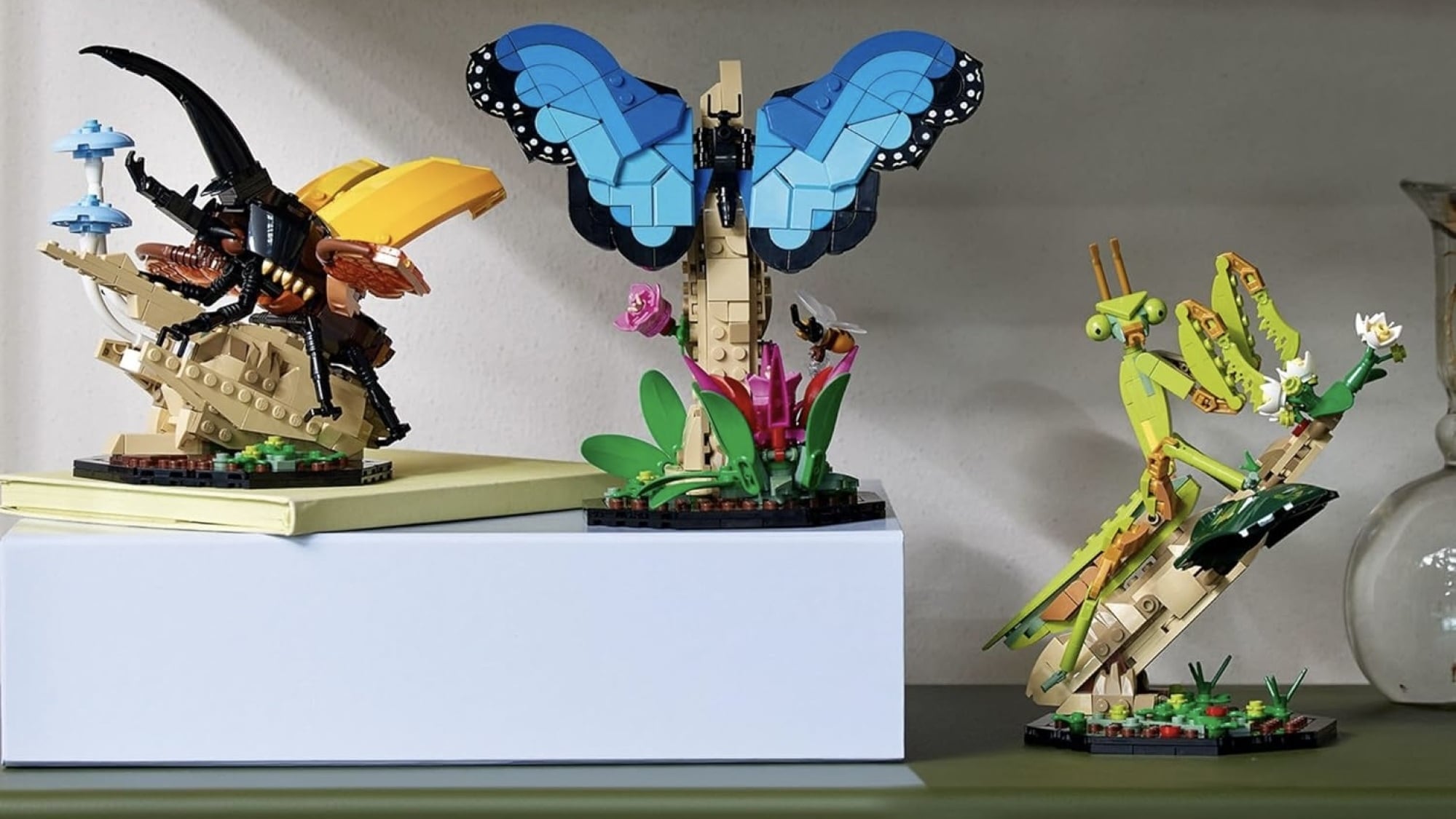 lego hercules beatle, blue butterfly, and chinese mantis posed