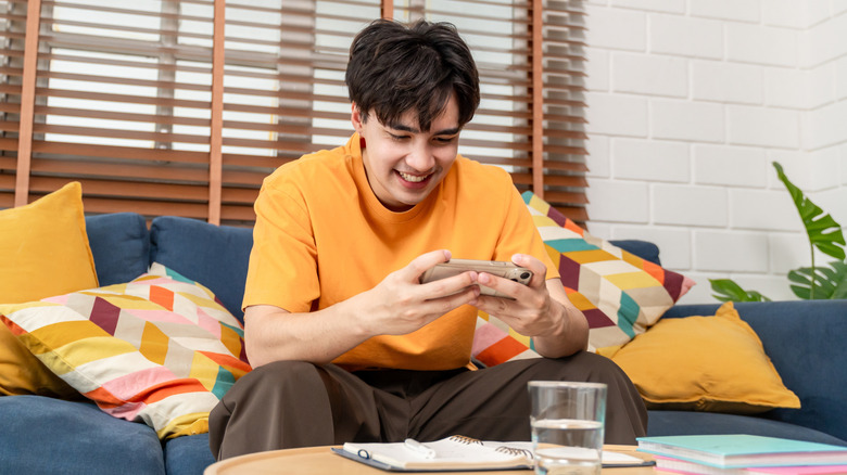 A person playing a game on their smartphone.