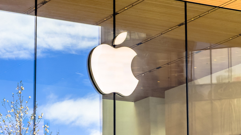 Photo of the exterior of an Apple Store showing the company logo on a glass storefront